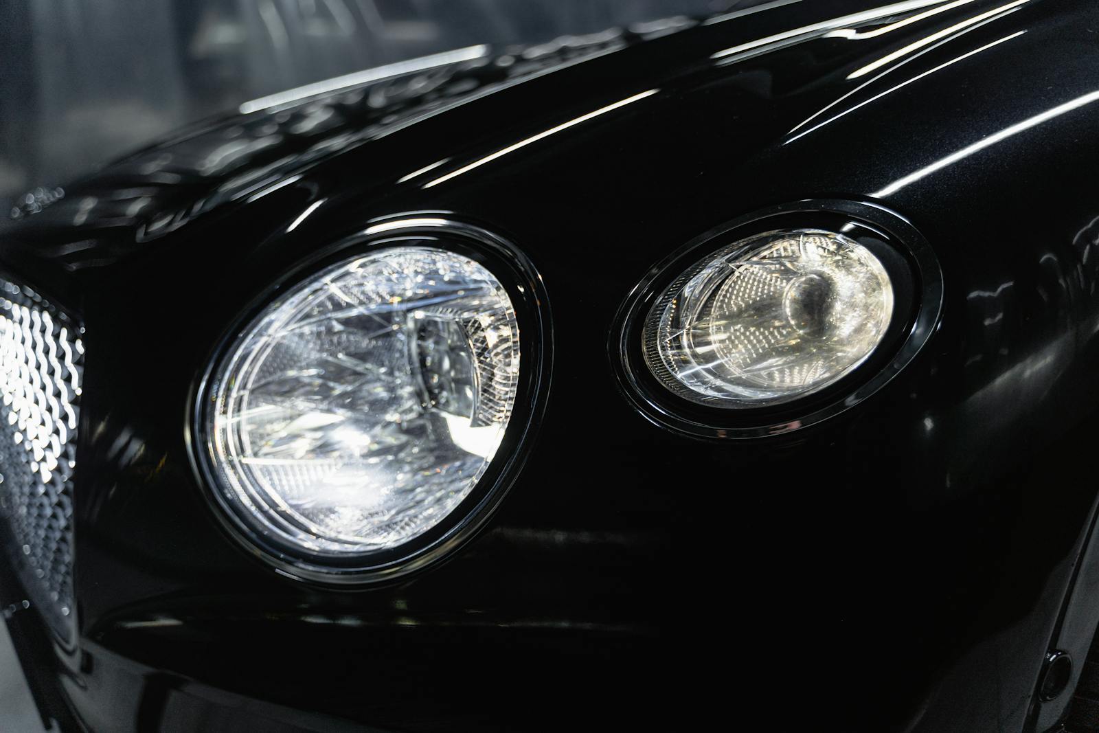 Professional auto detailer carefully polishing a luxury vehicle